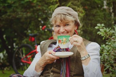 Portrait of smiling senior woman holding tea cup