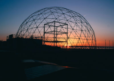 Silhouette of ferris wheel against sky during sunset