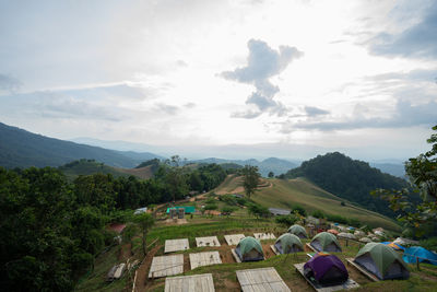 Panoramic view of trees and houses against sky