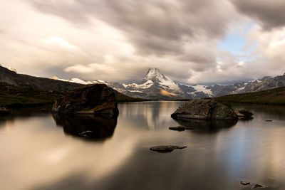 Scenic view of sea and mountains against sky