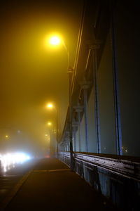 Illuminated bridge against sky at night