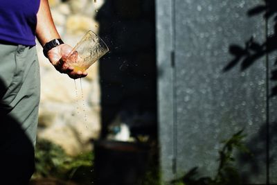 Man holding a splashing glass of juice