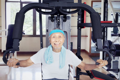 Portrait of confident senior man exercising in gym