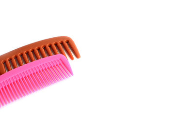 High angle view of pink pencils against white background