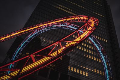 Low angle view of illuminated bridge against sky at night