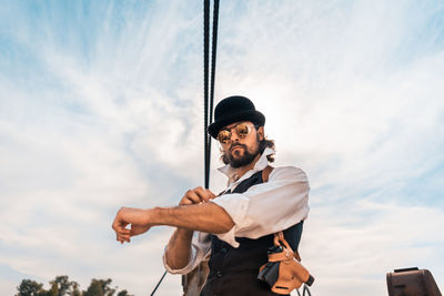 Low angle view of man standing against sky