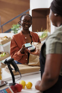 Portrait of young woman holding food at home