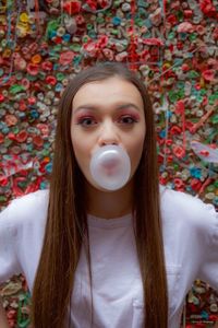 Portrait of woman blowing bubble gum