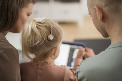 Side view of young woman using mobile phone