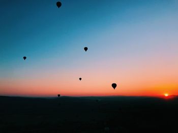 Silhouette of hot air balloon against sky during sunset