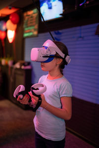Vr game and virtual reality. kid girl gamer eight years old fun playing on futuristic simulation