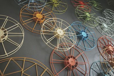 Low angle view of colorful wheel spoke hanging from wall