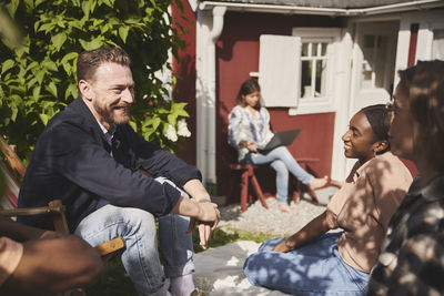 Friends sitting together in garden