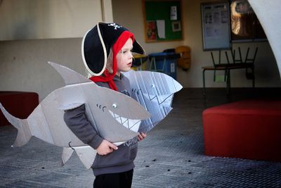 Cute boy wearing shark costume