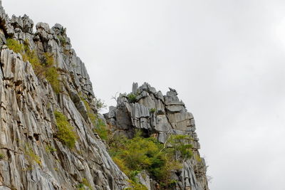 Low angle view of rock formation against sky