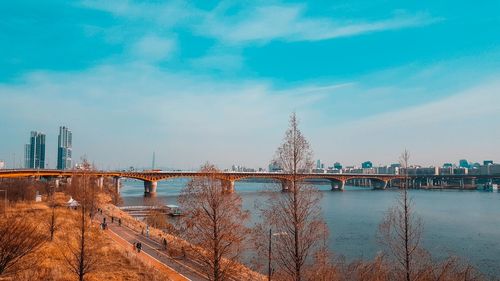 View of bridge over river against cloudy sky