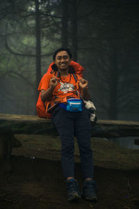 Full length of young woman using mobile phone