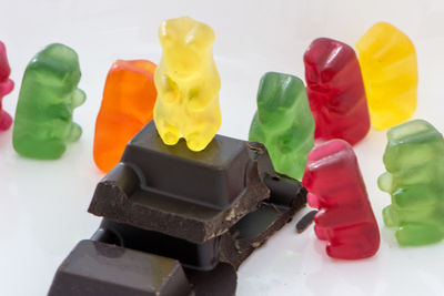 Close-up of multi colored candies against white background