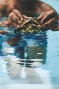 Close-up of man swimming in water