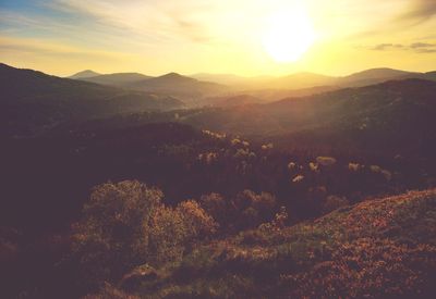 Scenic view of mountains against sky at sunset