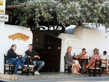 Group of people sitting in front of building