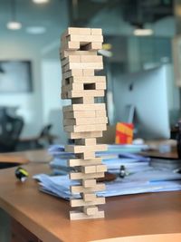 Close-up of toy blocks stacked on wooden table in office