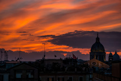 Buildings against cloudy sky during sunset