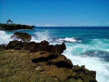 Scenic view of sea against clear blue sky