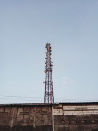 Low angle view of communications tower against sky