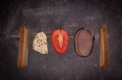 Close-up of fruits hanging on wood