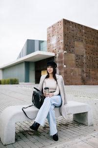 Young woman wearing sunglasses sitting outdoors