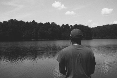 Rear view of man fly-fishing on lake