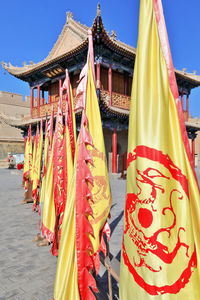 0797 row of yellow red flags line-wenchang pavilion-jiayu guan pass fortress. jiayuguan-gansu-china.