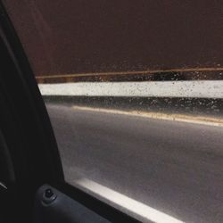 Close-up of car on road