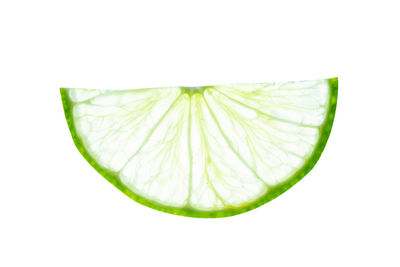 Close-up of green fruit against white background