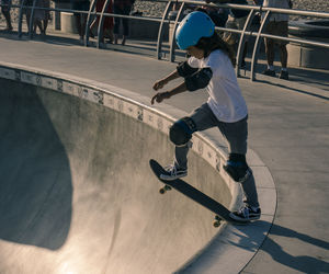 Full length of boy standing on skateboard