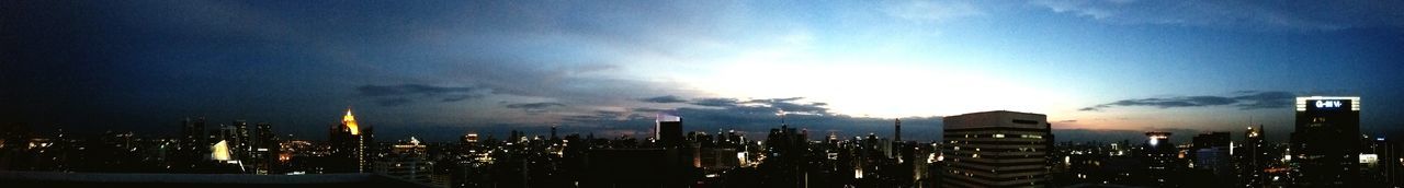 Illuminated cityscape against sky at night