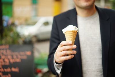 Cropped hand holding ice cream