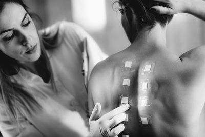 Immunologist doing skin prick allergy test on a womans back