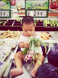 Midsection of child at market stall