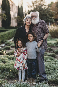 Traditional portrait of grandparents and grandchildren standing