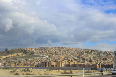 Houses on mountain against sky