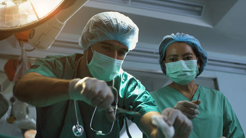 Midsection of doctor examining patient in laboratory