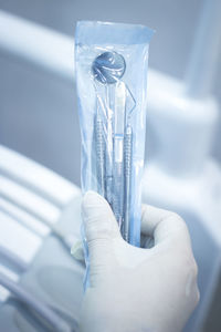 Cropped hand of surgeon holding medical equipment in hospital