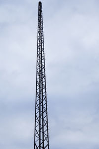 Low angle view of communications tower against sky