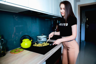 Mid adult woman standing at home