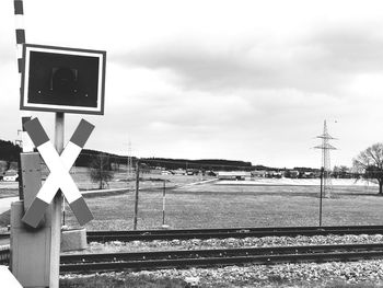 Road sign against sky