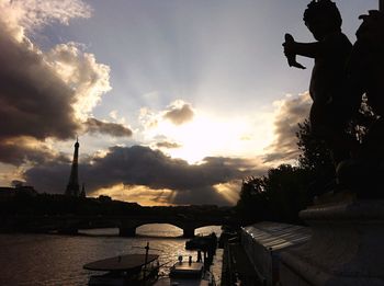 Silhouette of woman against cloudy sky