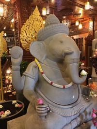 Buddha statue in illuminated temple