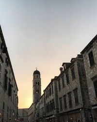 Low angle view of buildings against sky during sunset